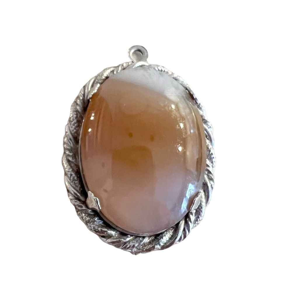 Milky brown agate ? pendant on intricate silver tone backing